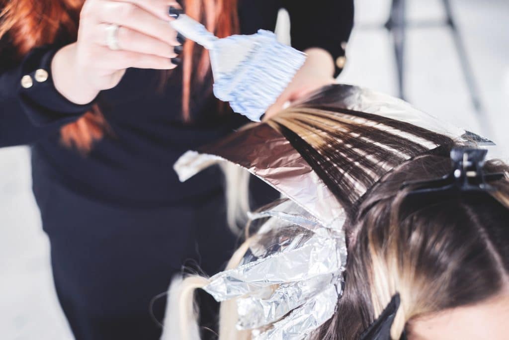 Salon stylist performing highlights