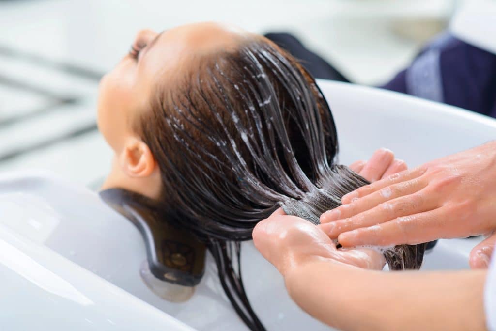 Woman receiving hair treatment